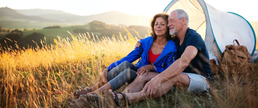 Older couple out camping because their arthritis and joint pain have been decreased by Wellward.