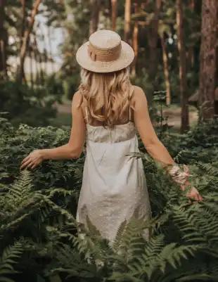 Woman is pain-free and walking through the forest.